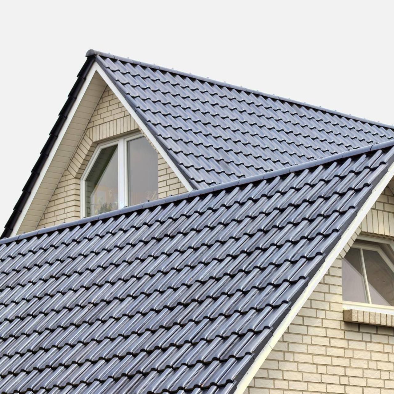 Grå metalltak med överlappande takpannor i modern design på ett bostadshus
